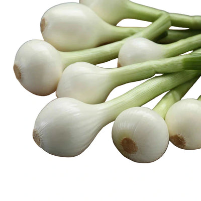 Onions on a wooden cutting board with a gray wooden background