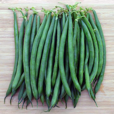 A group of green Southern Pea Lady Finger plants on a wooden surface.