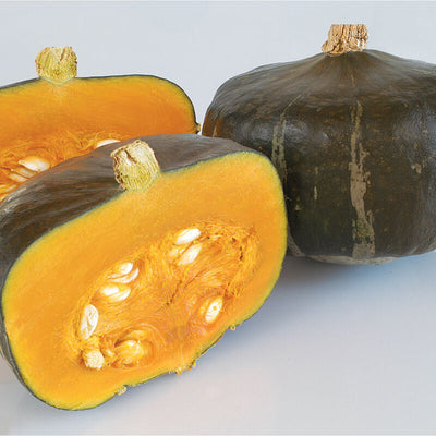 Image of a buttercup squash with one whole and one cut in half, displaying the inner flesh and seeds.