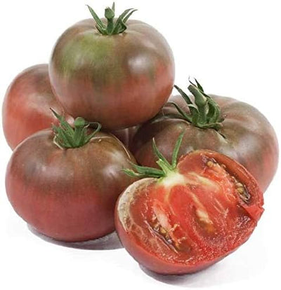 A cluster of Cherokee Purple beefsteak tomatoes with one tomato cut in half to show the interior.